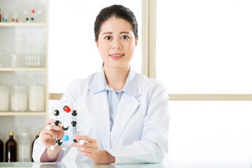 asian female scientist Examining the building blocks of life