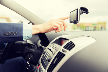 close up of man with gps navigator driving car