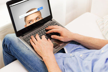 Fototapeta premium close up of man typing on laptop computer at home