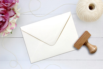 Mockup of envelope with a rubber stamp next to it.