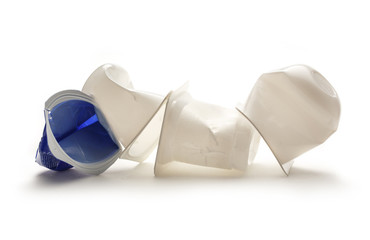 Empty crushed plastic yogurt pots