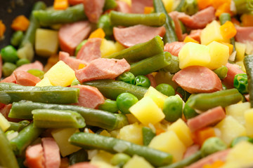 Vegetables with sausages fried