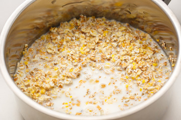Cooking healthy porridge in metal pot