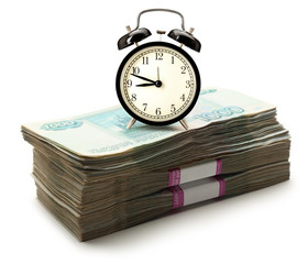 Pile of money and alarm clock
