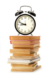 Old books and magazines with alarm clock