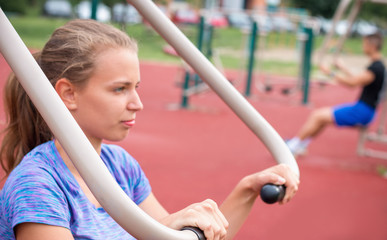Young people working out at outdoor gym