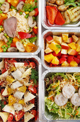 Healthy food take away in boxes, top view at wood