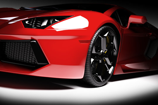 Red fast sports car in spotlight, black background. Shiny, new, luxurious.