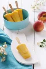 Homemade popsicles made with peaches. Summer dessert. Selective focus.