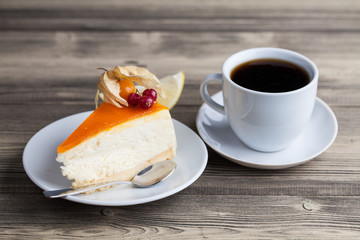 sweet cake with cup of tea on wooden table
