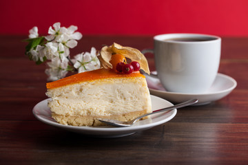 sweet cake with cup of tea on wooden table