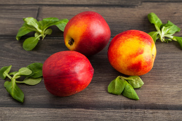 Ripe nectarines on a wooden table