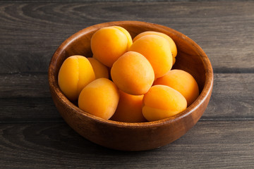 Fresh apricots on wooden background