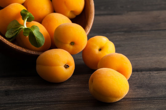 Fresh apricots on wooden background