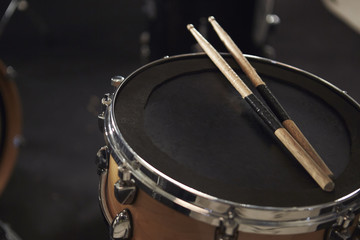 Fototapeta na wymiar Close Up Of Sticks Resting On Snare Drum