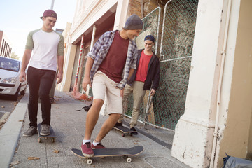 Guys skateboarders in street