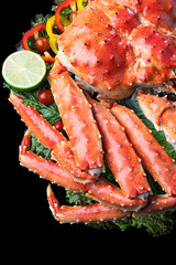 Top view of Red king crab served on black background