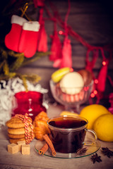 Cup of tea with cinnamon and anise on a celebratory Christmas background. Ukrashenieya.