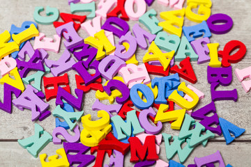 Multi-colored letters on a wooden table. Training. School.