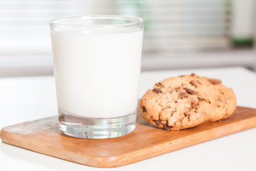 Stack of Chocolate chip cookie and glass of milk. Selective focus.