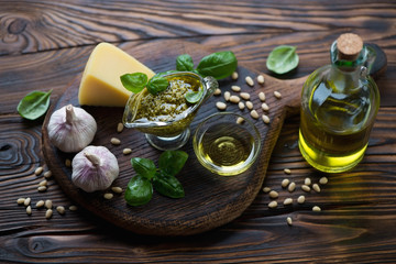 Ingredients for preparing pesto sauce in a rustic wooden setting