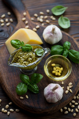 Fototapeta na wymiar Still life with freshly made basil pesto and cooking ingredients