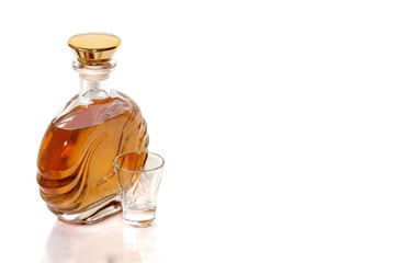 Bottle tequila and shot on white background