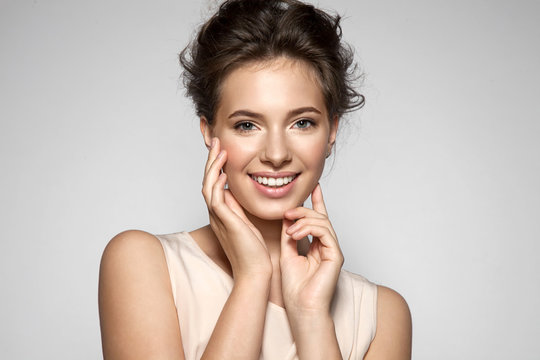 Portrait of a smiling young pretty woman with natural make-up