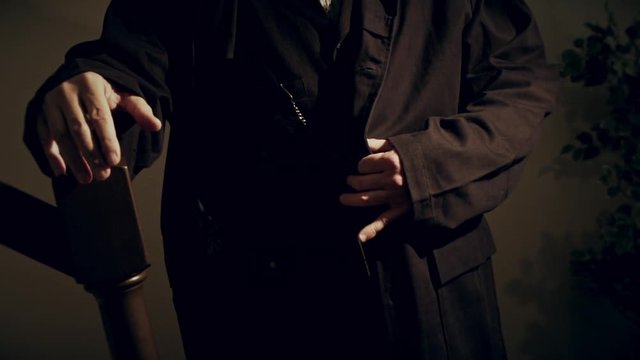 slow motion cowboy at foot of stairs pulls coat revealing pistol