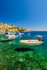 Fototapeta na wymiar The picturesque coast of the island of Symi, a popular tourist destination, Symi island, Dodecanese, Greece.