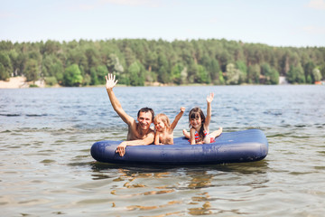 Family floating on mattresses.