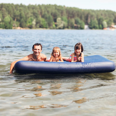 Obraz premium Family floating on mattresses.