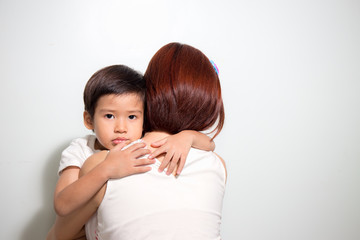 3 years old Asian kid hug his mother on white background