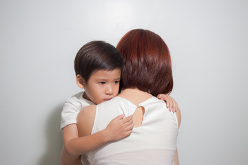 3 years old Asian kid hug his mother on white background