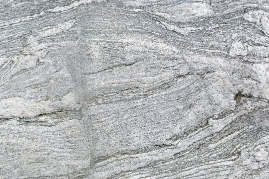 Textured background of a granite rock polished be glaciers during the ice age.