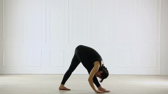 young beautiful woman doing yoga in the hall