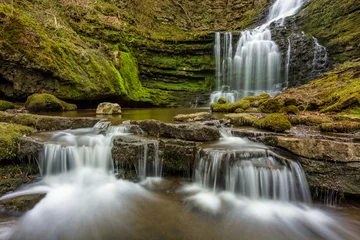 Foto op Aluminium Beautiful woodland flowing waterfall with small cascades in North Yorkshire, UK. © _Danoz