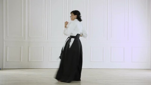 beautiful woman wearing a hakama engaged in Jiu Jitsu 
