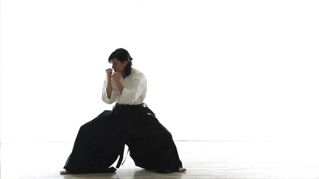 beautiful woman wearing a hakama engaged in Jiu Jitsu 