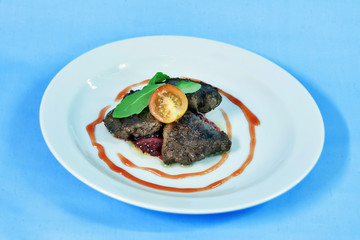 Modern food on a white plate and blue background