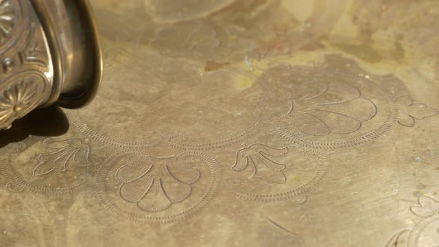 Brass made holy grail and beautiful textured plate 4K 3840X2160 UHD footage - Holy grail on brass plate with beautiful texture 4K 3840X2160 UHD video 