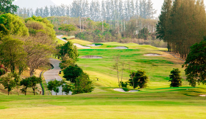 Golf course with gorgeous green and pond.