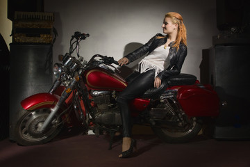 Fototapeta na wymiar Two beautiful rock girl friends at rock club with motorcycle