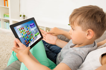 Little Child Playing Game On Digital Tablet