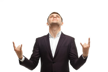 Handsome businessman shows rock gesture