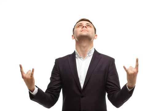 Handsome businessman shows rock gesture
