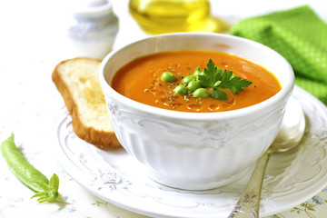 Carrot creamy soup with green pea.