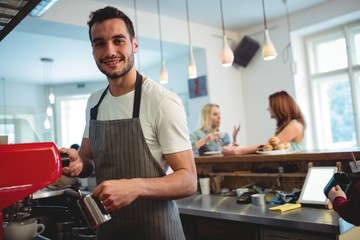 Fototapeta premium Portrait of happy barista at coffee shop