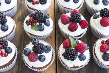 Cupcakes with Fruits on a Rustic Wooden Table