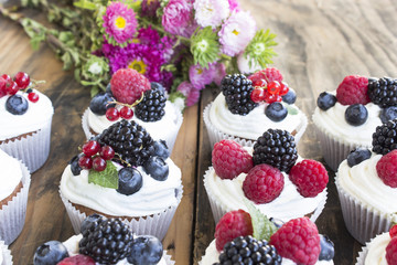 Cupcakes with Fruits on a Rustic Wooden Table